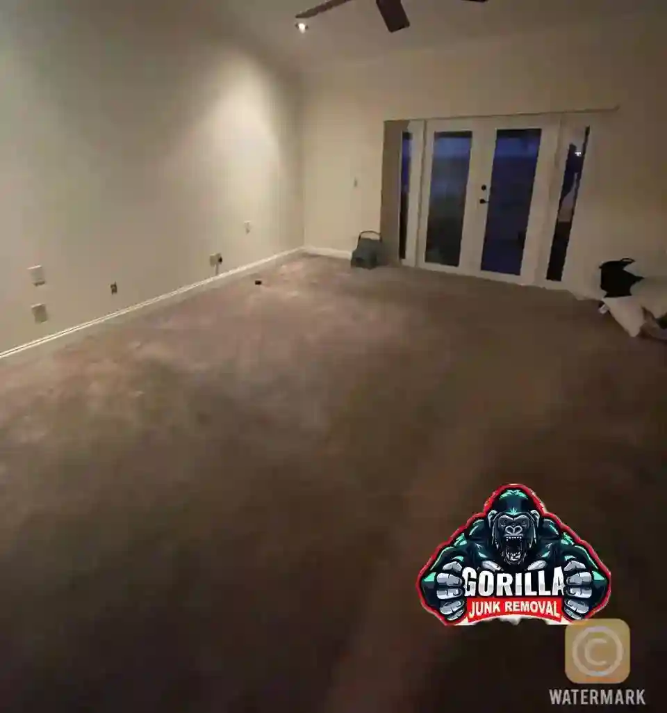 Clean, empty bedroom with carpet and French doors after junk removal service cleared out all old furniture for a fresh start