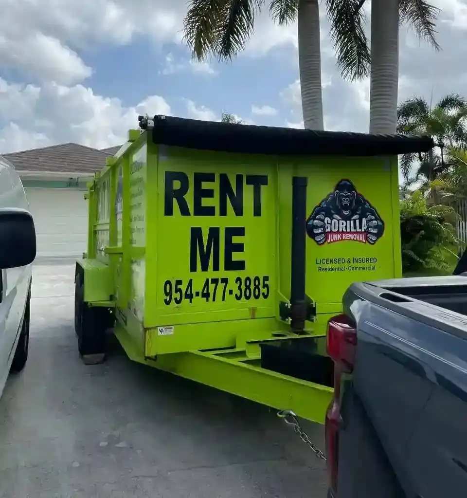 Bright green Gorilla Junk Removal rental dumpster parked in a driveway for easy home or commercial junk disposal