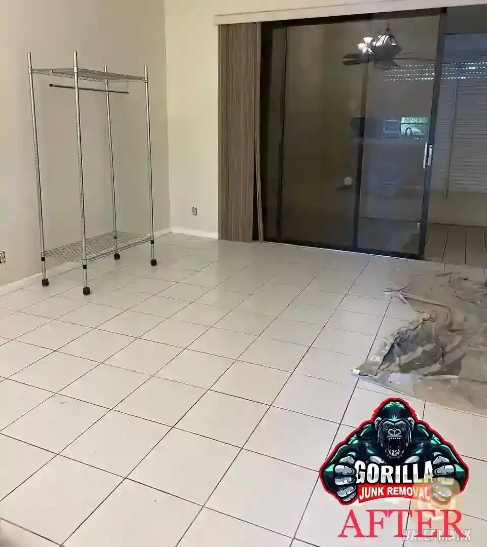 Clean, empty living room with tiled floor after junk removal service cleared out all old furniture and debris