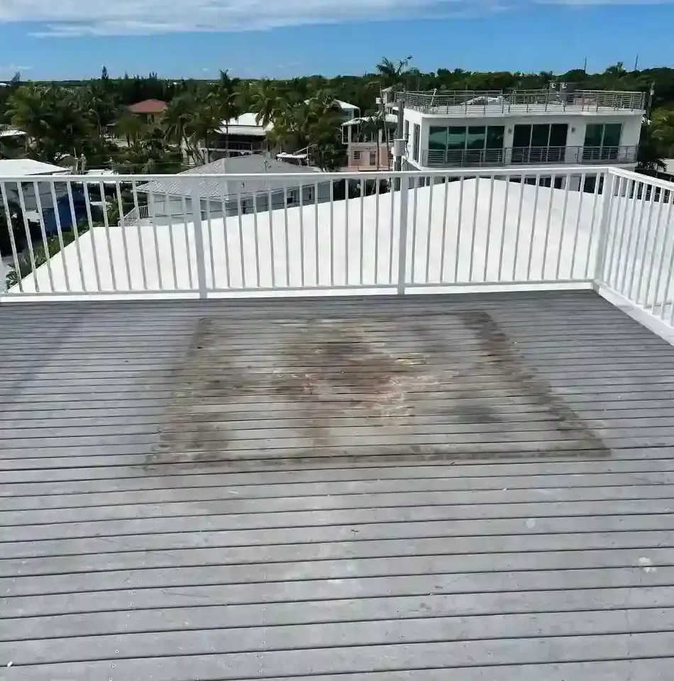 Clean, empty rooftop deck with visible stain where hot tub was removed, ready for new installation or landscaping