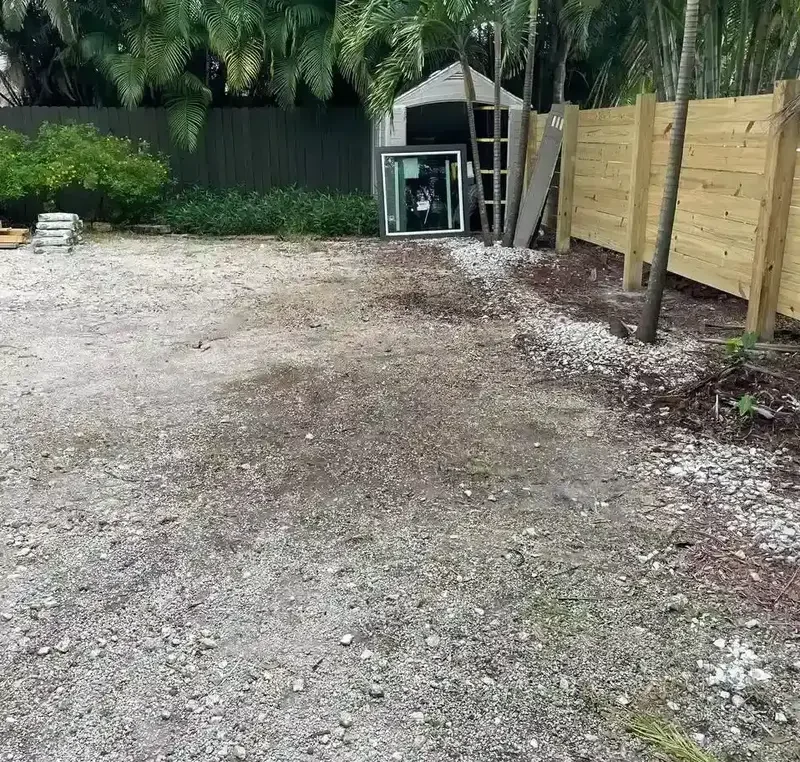 Clean, empty gravel yard after junk removal service cleared all renovation debris, perfect for next project or landscaping