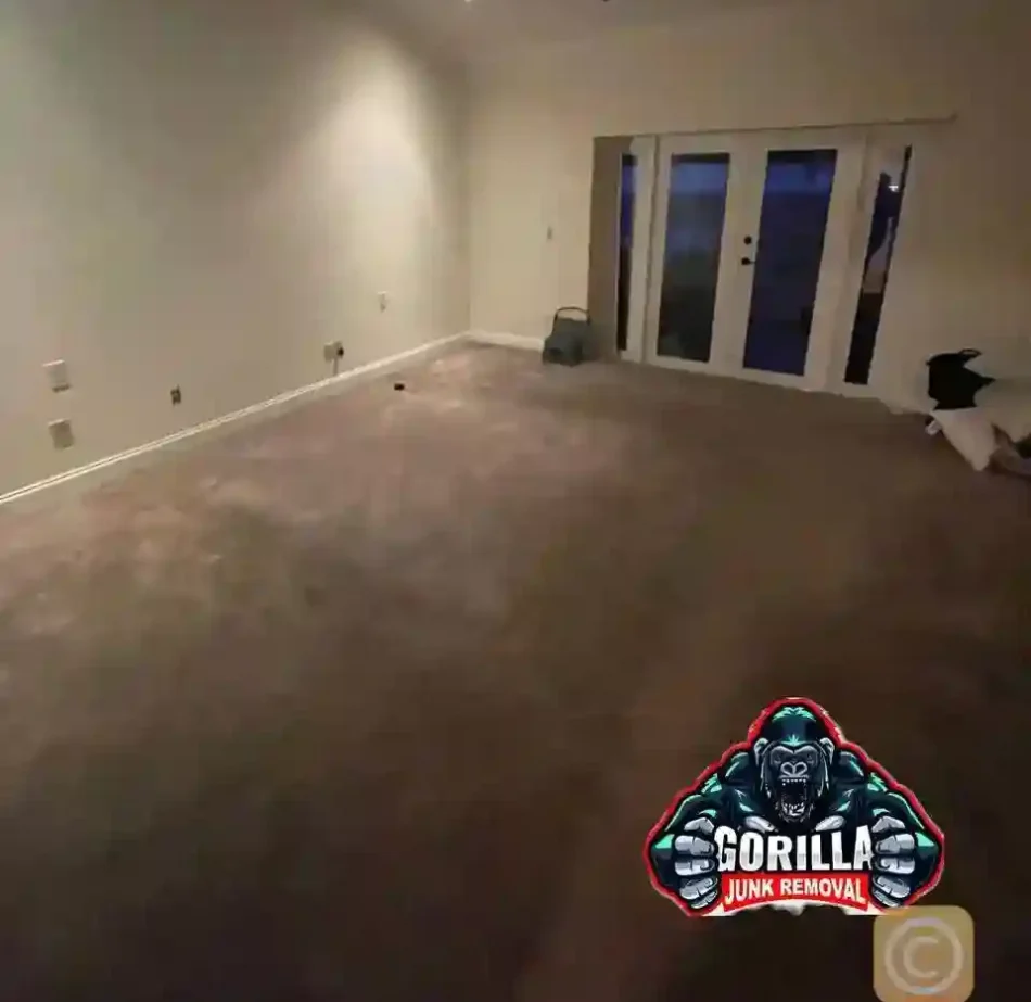 Clean, empty bedroom with carpet and French doors after junk removal service cleared out all old furniture for a fresh start