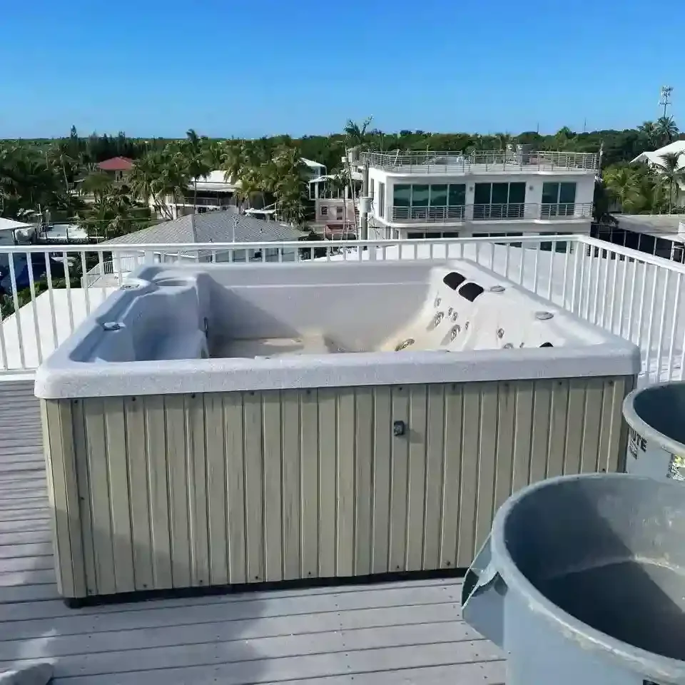 Large hot tub installed on a rooftop deck before junk removal service for replacement or renovation