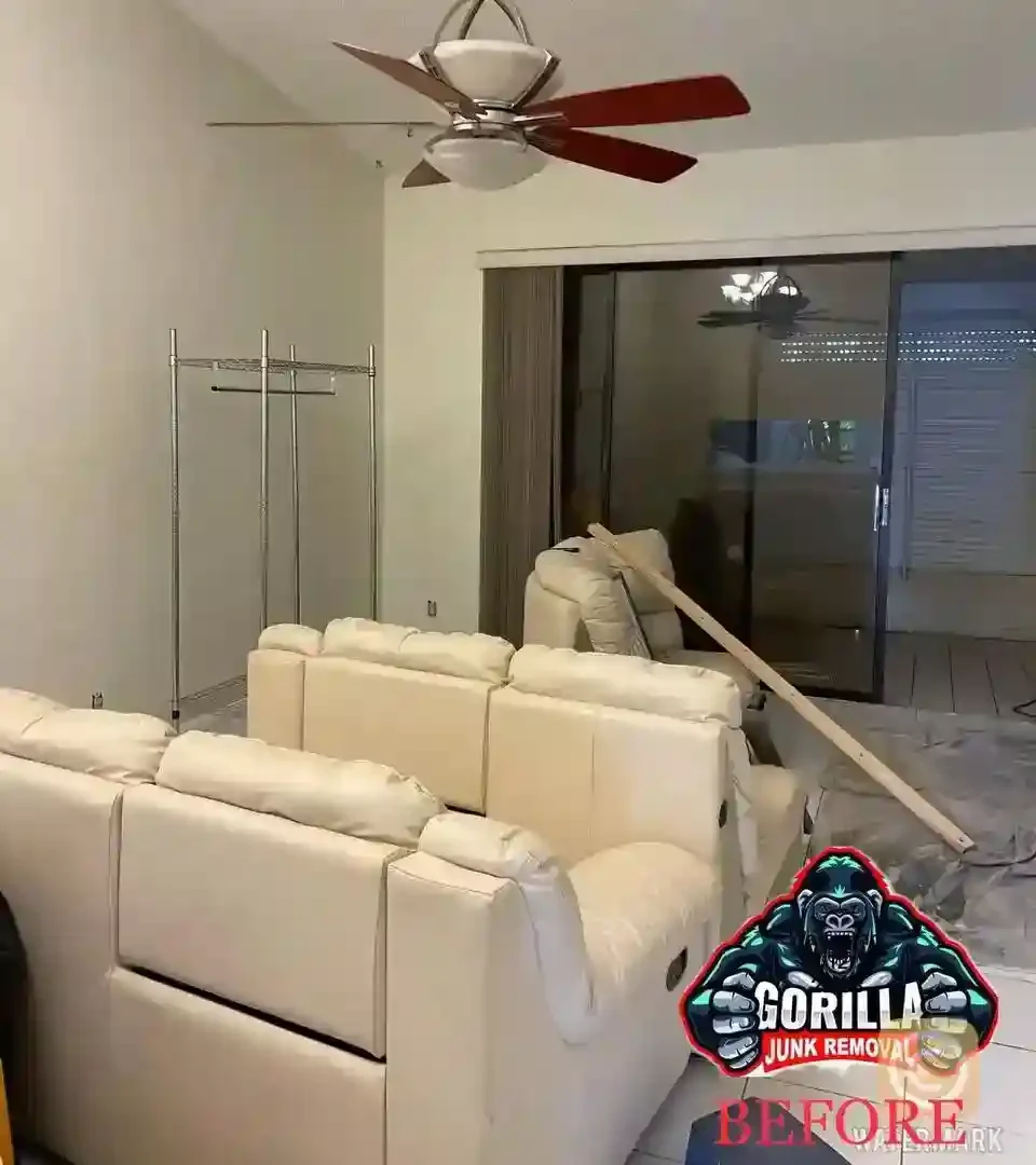 Living room cluttered with large white recliners and a metal rack before junk removal service for renovation or move-out